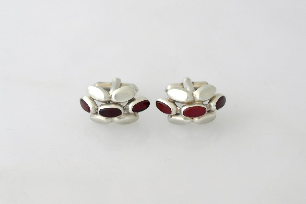 Being offered is a pair of circa 1950 .970 silver and carnelian cufflinks by Antonio Pineda of Taxco, Mexico, in a modernistic design of even measured sections of silver and precious tone carnelian measuring 1 inch by 1/2 inch.  Marked.  In