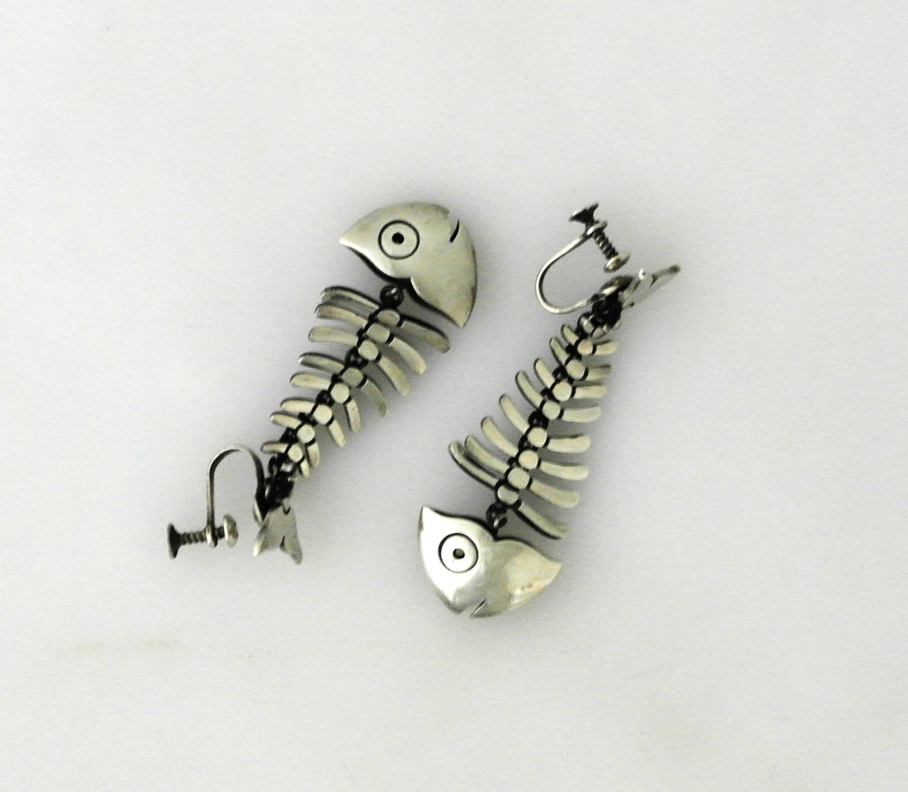 Being offered is a pair of circa 1950 sterling silver earrings by Antonio Pineda of Taxco, Mexico.

Modernist Earrings by World Famous Antonio Pineda--these earrings are longer, having 10 vertebrae, rather than the shorter version, which has 7.