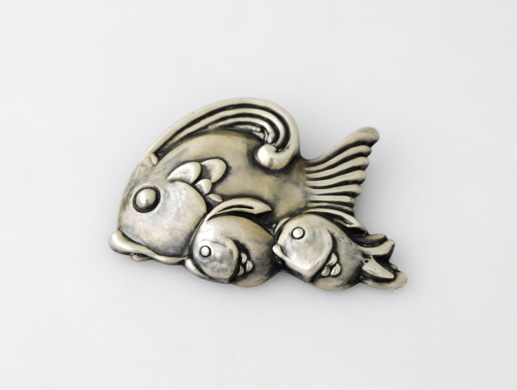 Being offered is a circa 1960 sterling silver brooch - pin by Los Castillo, of Taxco, Mexico, a dimensionalmotif of three swimming fish. Dimensions 3 inches by 2 1/4 inches.  Marked.  Excellent condition.