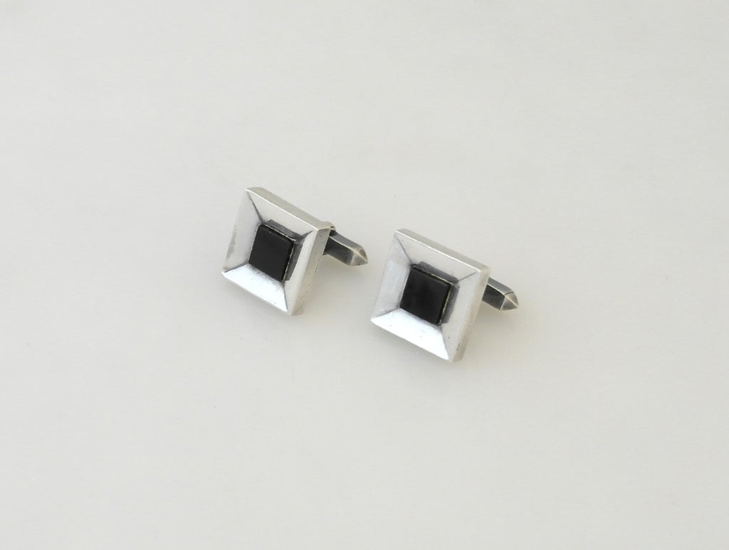 Being offered are a pair of onyx and .970 silver cufflinks by Antonio Pineda, of Taxco, Mexico, in a straightforwad  moderne design.  Dimensions 3/4