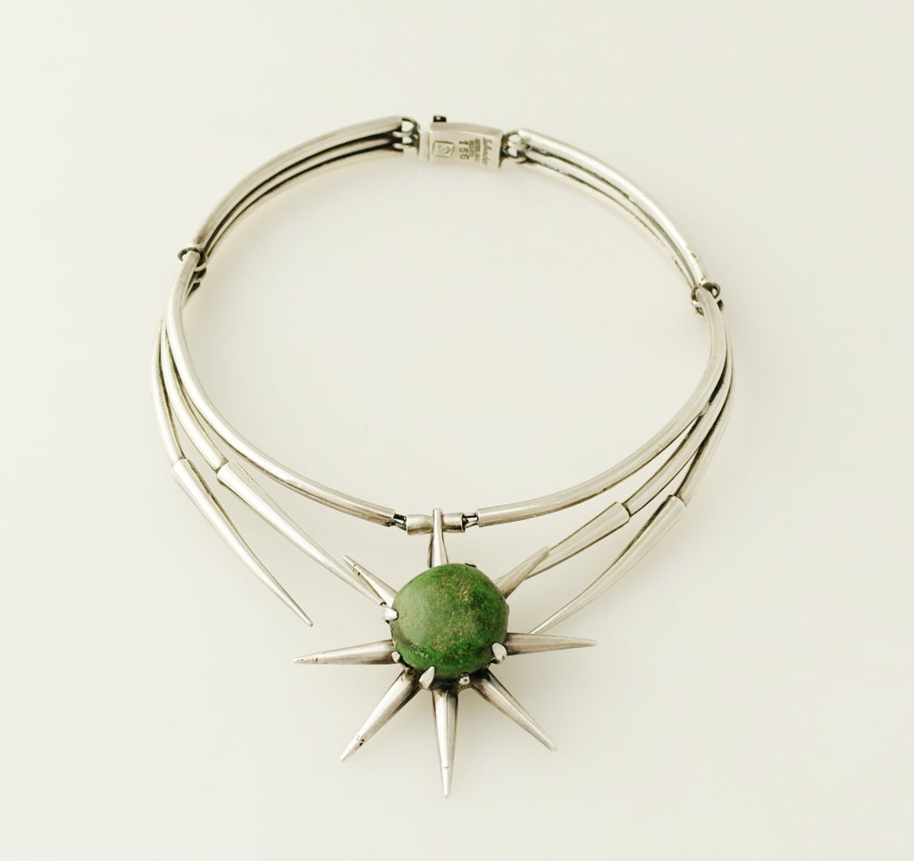 Being offered is an exceedingly rare circa 1960 sterling silver and jade necklace by Salvador Teran of Taxco, Mexico, of modernist design in a star burst motif, the center star measures 2 1/4 inches in diameter.  Measures 13-1/2" in total