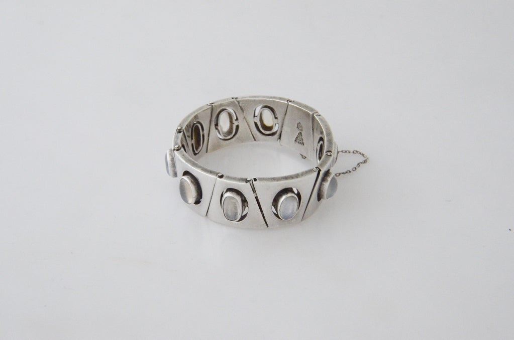 Being offered is a circa 1960 sterling silver and moonstone bracelet by Antonio Pineda of Taxco, Mexico, in an art deco motif, with 10 trapezoidal links set with moonstones. Tongue & box closure with security chain. Construction is superb.   Weighs