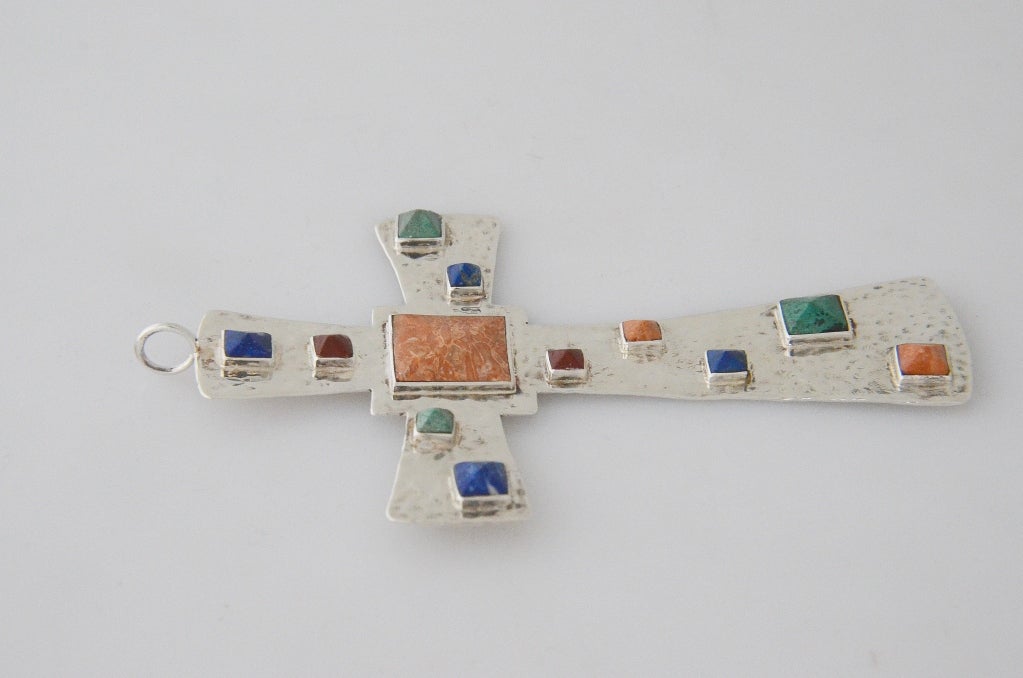 Being offered is a circa 1990 sterling silver pendant by Emilia Castillo, of Taxco, Mexico, in a cross motif with a variety of applied stones including lapis lazuli and malachite.  Dimensions 3 3/8 inches wide by 4 7/8 inches high.  Marked as