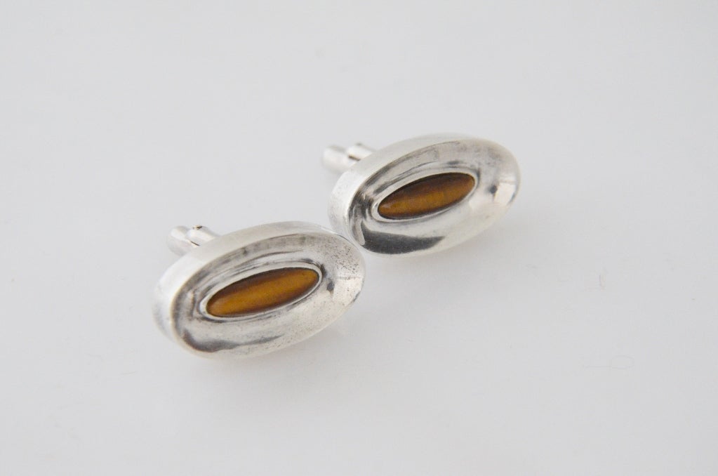 Being offered are a pair of circa 1960 sterling silver cufflinks by Anotonio Pineda, of Taxco, Mexico, featuring central tiger eye focal points.

Stanley Szaro Antonio Pineda Collection