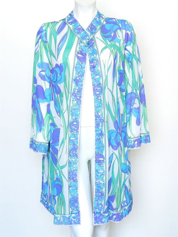 This fun, floral Emilio Pucci piece was originally designed as a shortie peignoir or robe, but it could easily double as a mini dress with a slip or as a light jacket. It would also make a great beach or poolside cover-up. It has a pocket in the