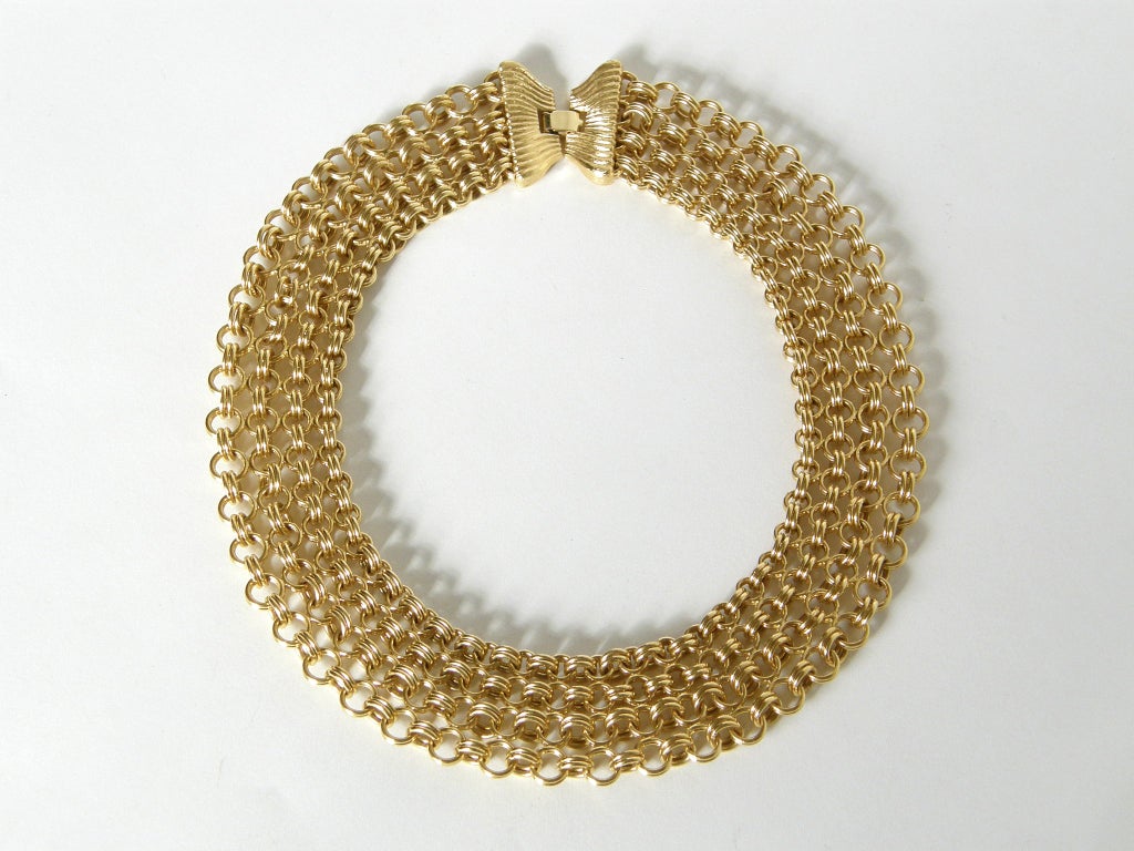 This goldtone, chain mail necklace by Monet has a nice weight, so it lies beautifully and feels great on.

Please contact us if you have any questions.