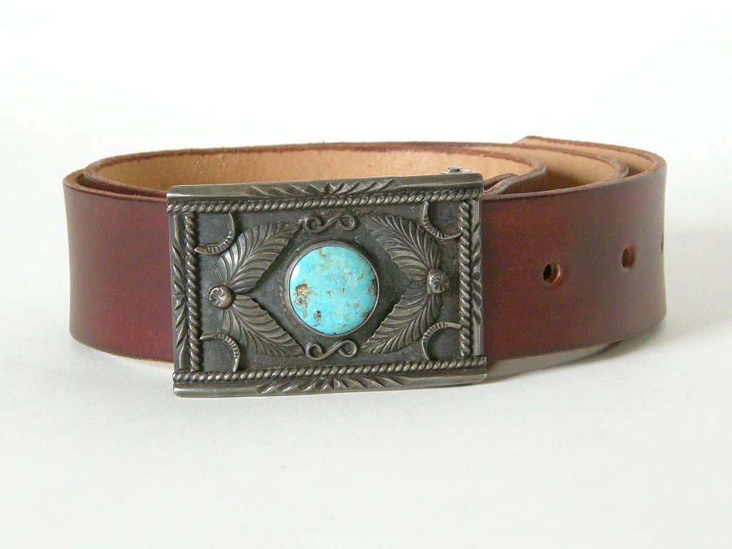 This handsome belt has a sterling and turquoise buckle handmade by Navajo silversmith, Dan Oliver. The buckle measures 3