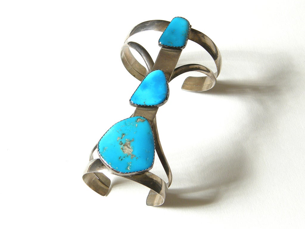 Long, Native American double cuff bracelet set with large turquoise stones with organic forms. The dramatic design is high impact with the bracelet covering a good part of the forearm.

Please use Contact Dealer Button if you have any questions.