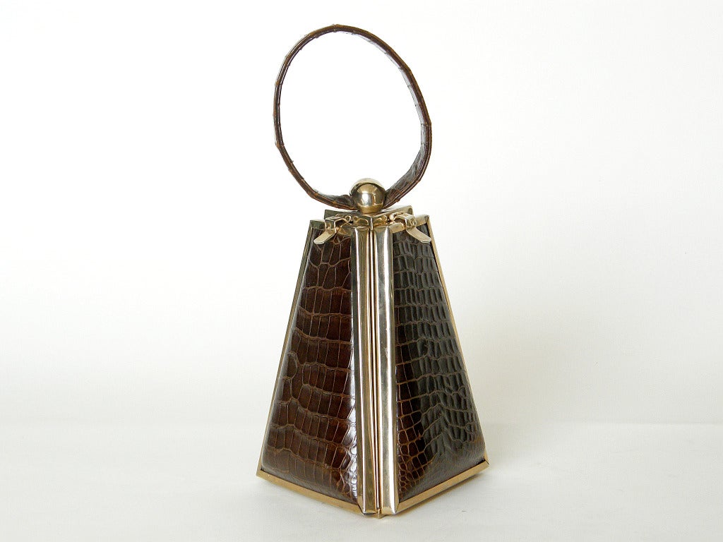 Rare, alligator panel pyramid bag by Tyrolean. This organizer bag has a complex construction and makes excellent use of its unique form. Each of the three panels drops down to reveal a different part of the bag. The sections are marked 