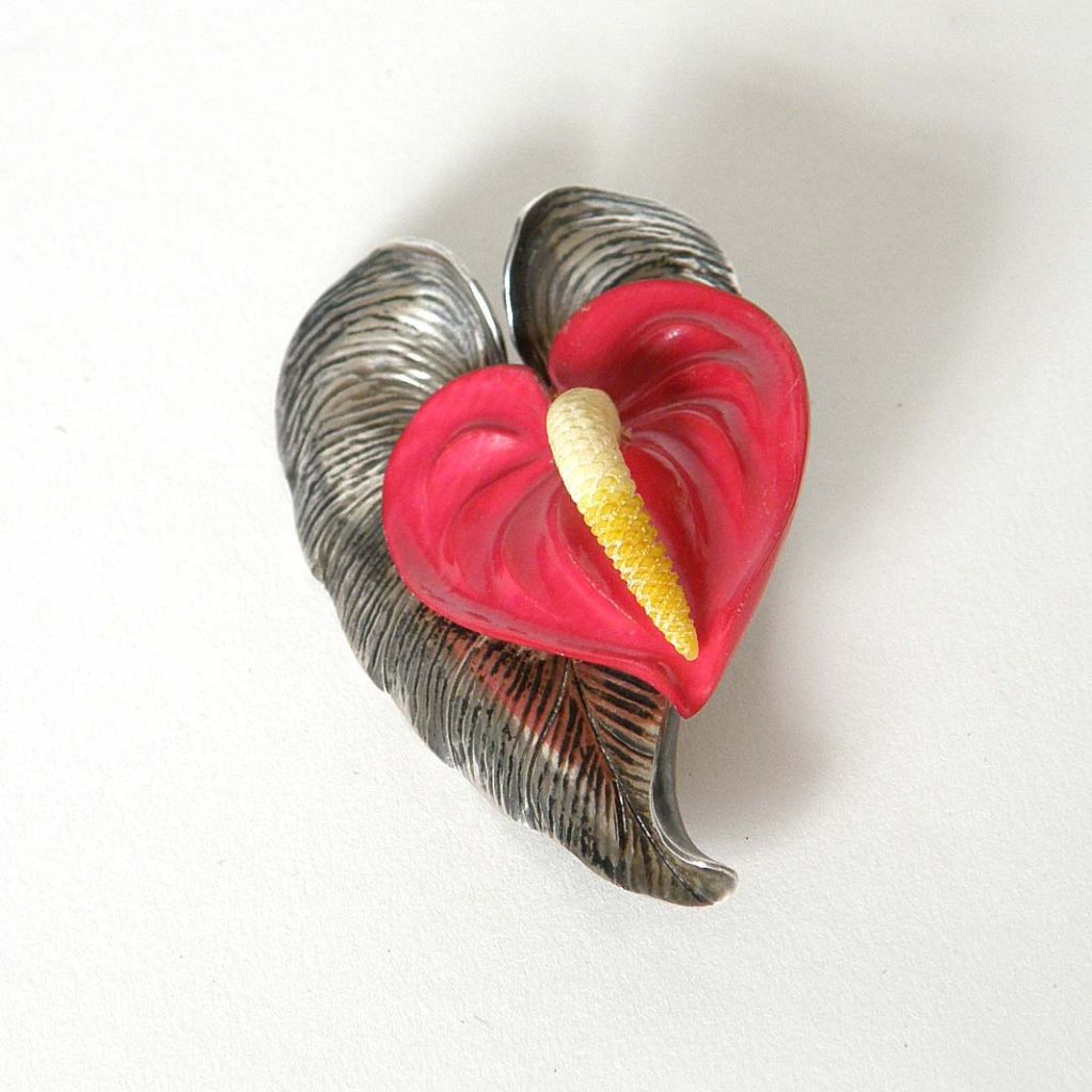 This lovely brooch is in the form of an anthurium flower. The leaf is made of sterling and the flower is made of carved and tinted ivory. This piece comes from the famous Ming's jewelry shop. The first Ming's shop was opened in Honolulu in the early
