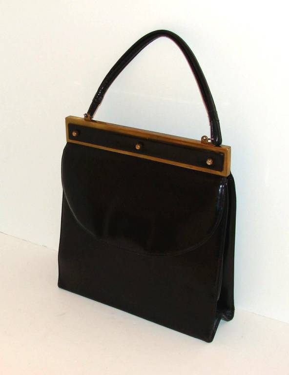 Rare example of a black calfskin handbag purse by Elsa Schiaparelli.

The construction, materials and label suggest the bag was made in the 1930's.

The materials, Handle drop:6".  Overall height, including handle:  16"