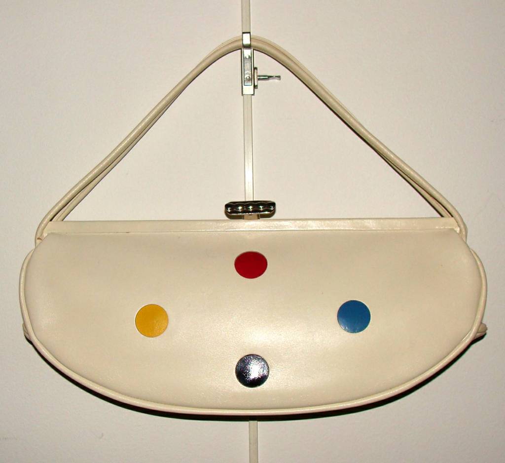 This mid-century purse is capacious and unique. It is the only one we have seen.

The double handle will fit over most shoulders and tucks right under the shoulder.  However, it was originally designed to be worn over the forearm or hand