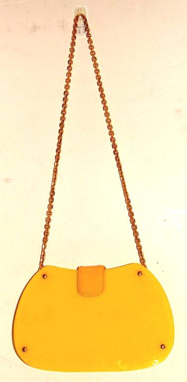 A good customer consigned this bright yellow lucite purse with optional original chain shoulder strap.  We have never had this form or color.

This can be worn with your 