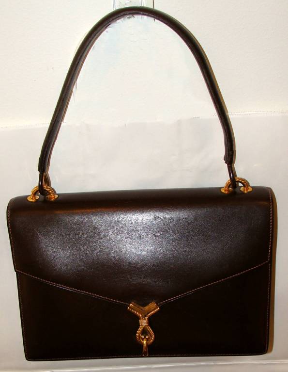 This timeless handbag is an Hermes classic.  Dark Brown boxcalf with hardware and clasp in a deep, rich gold plating over brass.  This is perfect for everyday or dressier occasions.  

The usual Hermes markings are can be found on the pocket under