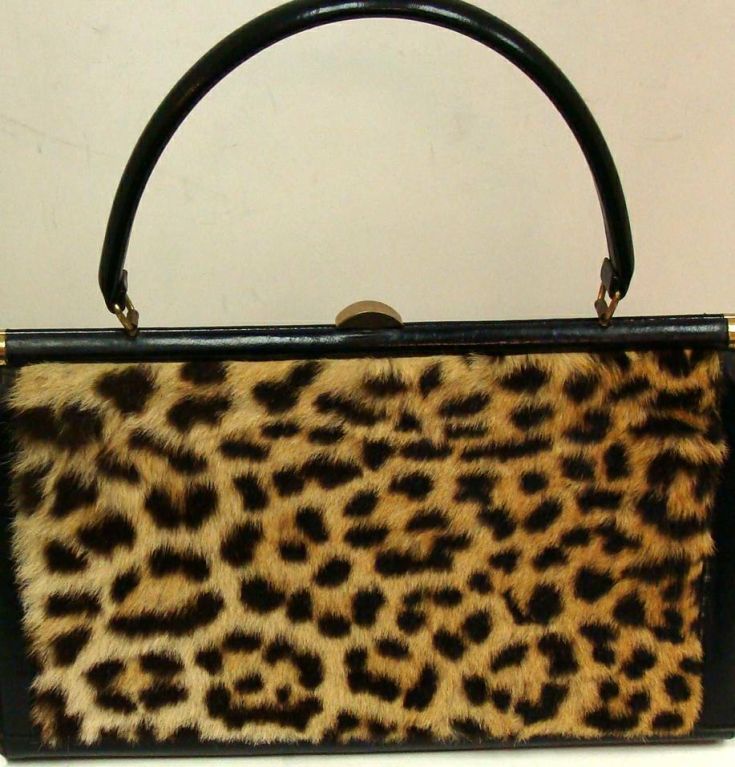 1960's exquisite kelly style bag with rich, vibrant leopard  front and back panels.  Brass corners and clasp.<br />
<br />
Purse rests on 4 gold feet.  Black leather wrapped frame and handle.  Black leather bottom and gussets.   <br />
<br