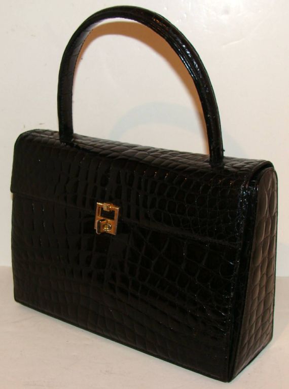 Elegant black crocodile handbag.  Choice, glossy skins used for front, back, side panels and bottom.  

Great size for day to evening.  

This bag is worn over the forearm or carried by the handle.  The handle drop is 4 1/2