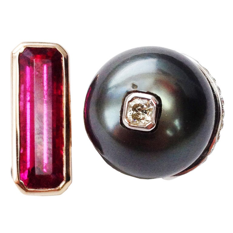 Bold 18k Estate 1970s Black Pearl Ruby Diamond Ring
Fabulous 18k Rose gold 1970s Handmade Black South Sea Pearl Ruby and Diamond Ring, featuring a beautiful black pearl, measuring approx. 15.5mm centered by a round cushion-cut diamond in white gold