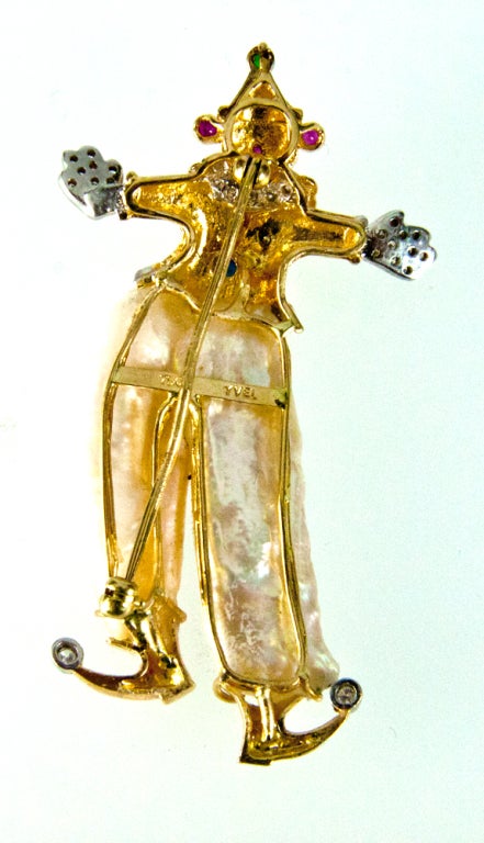 Featuring a Unique Vintage Multi-gem Clown Pin Pendant, hand crafted in 18k Yellow Gold; the clown is wearing Cultured Freshwater Pearl Pants and diamonds on the toes, hands,  suit and around his neck; accented by twinkling ruby, sapphire and