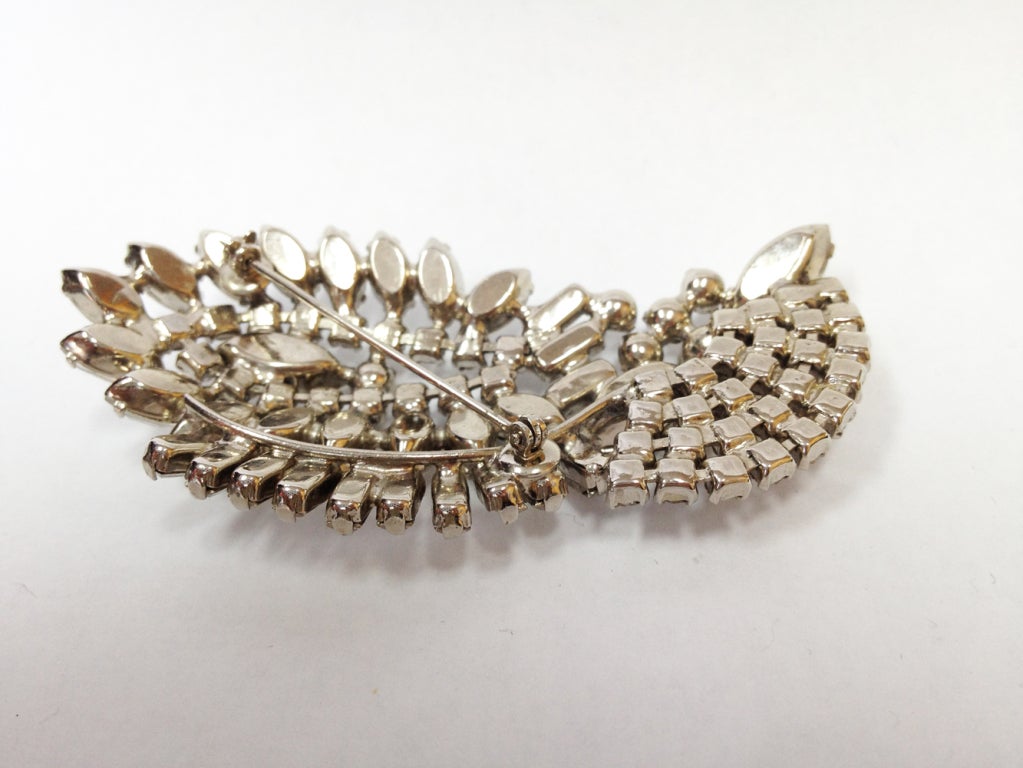 A stunning stylized Retro wing pin set with clear marquis, rectangular and round-cut Swarovski Crystals; approx. length: 2”.  Circa: 1950s. A Sparkly Classic to make you shine! 