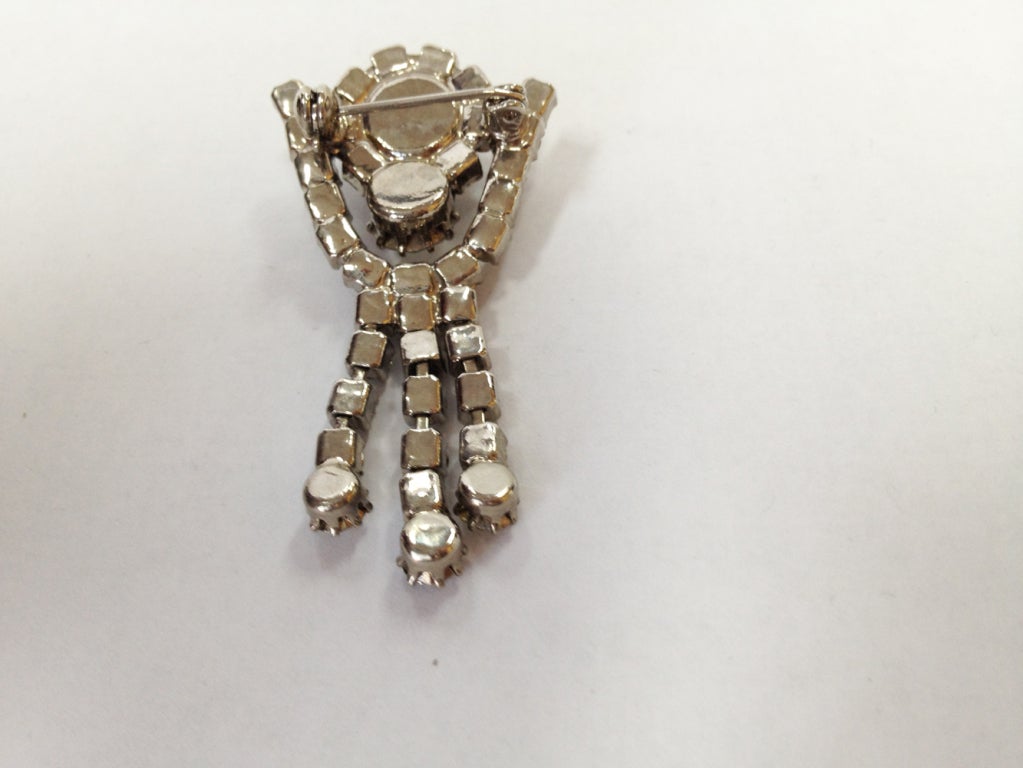 A stunning Retro stylized figural Tassel pin set with clear round Swarovski Crystals; approx. length: 2”.  Circa: 1950s. A Sparkly Classic to add pizzazz to anything you wear! 