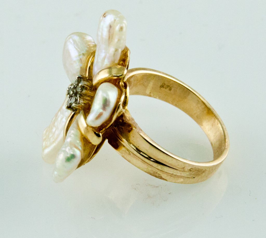 Stunning 14K yellow gold Ring with five Free-form Pearl Petals centered by a Diamond Star Cluster. Shank marked: 14K; top measures approx. 27.5mm x 20mm; approx. ring size: 7. Chic, Classic and Timeless...Chic and sure to be admired complement to