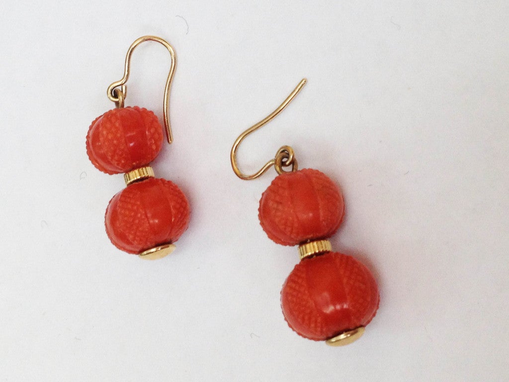 Beautiful Victorian Hand Carved Coral Double Ball set on 14K Gold Mountings. Marked on earring backs: 14K. Approx. length: 1 1/2
