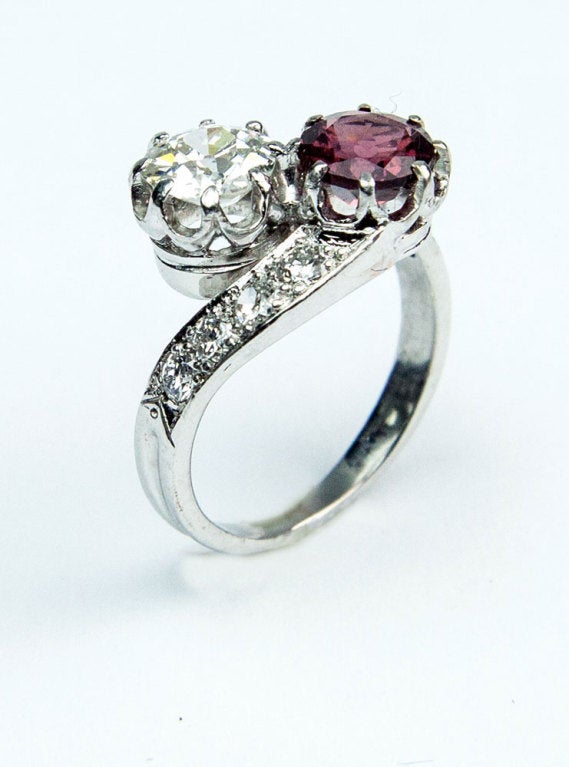 Beautiful 'Toi et Moi' Crossover Diamond and Rubellite Garnet Handmade Ring, the old European-cut, cullet-cut diamond weighing approx. 0.80 ct. (5.9mm x 3.5mm); H color; VS2; to the opposing round rubellite garnet, weighing approx. .76ct (5.9mm x