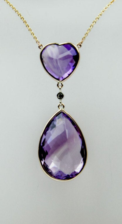 Beautifully crafted Amethyst hand  Pendant, suspending heart and teardrop Amethysts, centered by a round, brilliant-cut Diamond; weighing approx 0.07ct; facet checkerboard-cut Amethyst heart measures approx. 15mm x 15mm; teardrop: 28mm x 19mm