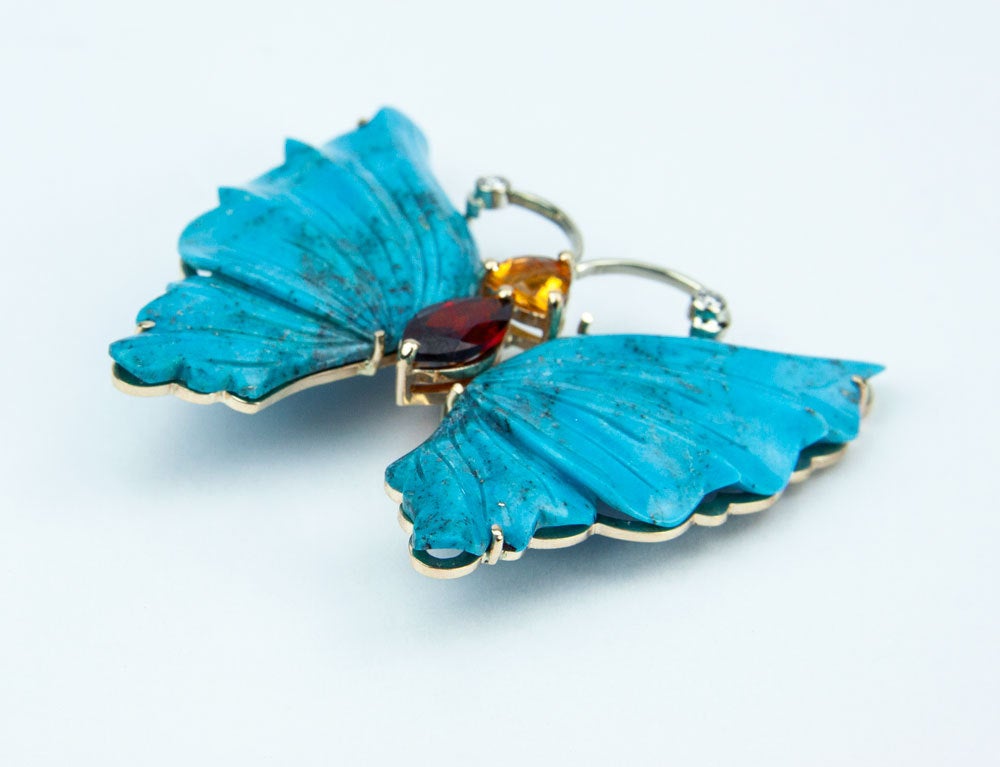 Beautiful Natural Turquoise Butterfly Brooch Pin Pendant; the antennae are bezel set with diamonds and the head with a Trillion Citrine and the body a Marquis Garnet. Beautifully hand crafted in 14 Karat yellow Gold; measuring approx. 2 