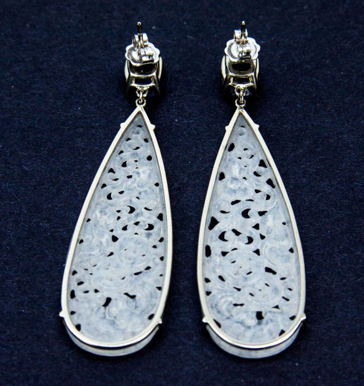 Beautiful pair of large hand carved teardrop icy jade drop earrings dangling from facet-cut blue Spinels, handmade with excellent craftsmanship utilizing fine precious stones and metal; the jades' color is exceptional, very translucent. Each jade