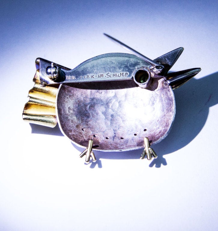 Beautiful Walter Schluep Figural Bird Pin; 18k and Sterling Silver; eye set with Green Tourmaline, approx. size: 48.5mm x 31mm. Marked: STERL. + 18K SCHLUEP plus his trademark signature. all handmade, silver hand hammered; circa: 1990;