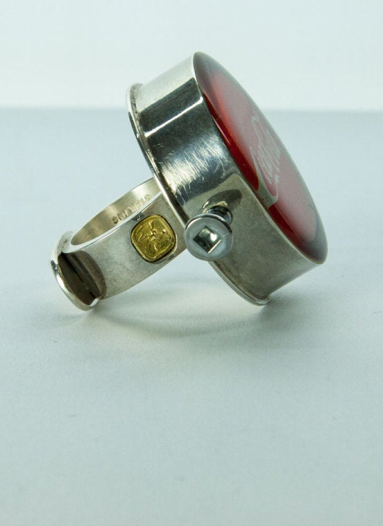 Amazing Walter Schluep Coca-Cola Sterling Silver Ring; Rare and Collectible, the Real Thing! Beautiful Red Epoxy Enamel top housed in sterling silver with a stainless steel screw each side. Wow! How cool is that! Top of ring measures approx. 34.5mm