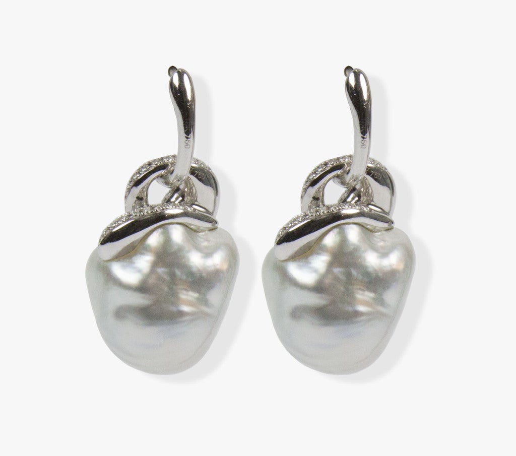 Stunning pair of South Sea Pearl and Diamond 18k Gold Earrings
Each earring centers a Beautiful South Sea Baroque Pearl in diamond encrusted knot style cap, suspended from a removable huggie; Each pearl measures approximately 17 x 18 mm, with good