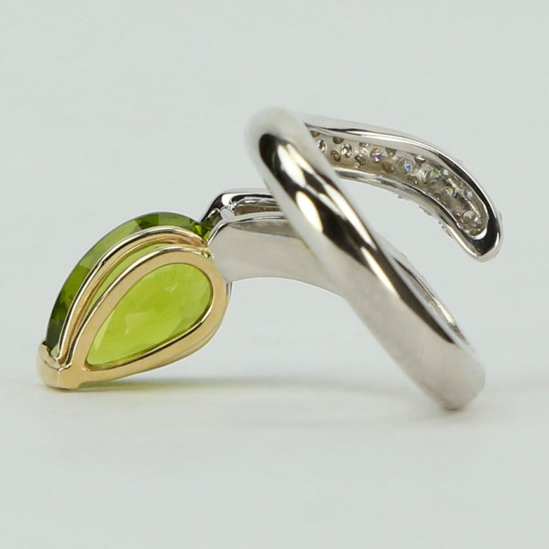 Stunning 4.69 Carat Peridot and Diamond Runway Snake Serpent Ring, hand crafted in 14k white and yellow gold; Ring size: 6.5
Approx. weight of pear shaped Peridot: 4.69 ct.; Diamond weight: 0.70 ct. The perfect accessory for the modern woman!