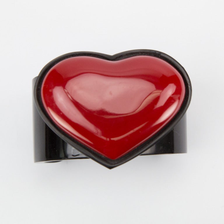 Dramatic Art Deco Large Red Heart Cuff Bracelet; deep red heart framed by black surround on black Celluloid Galalith cuff bracelet. 
Heart measures approx: Approx 2.5inches x 2.0inches; bangle fits average wrist size. Make a style statement with
