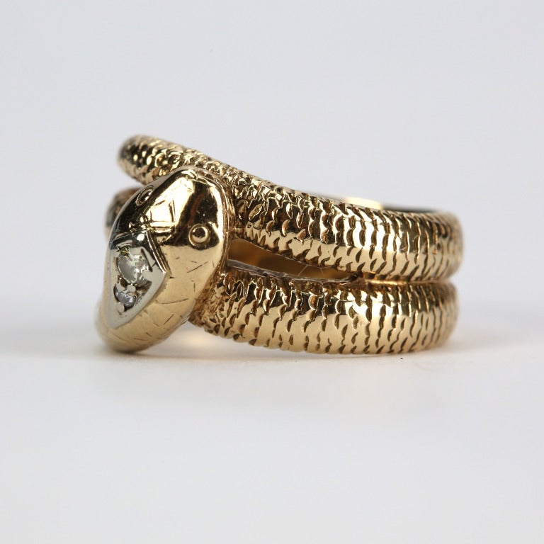 Striking Art Deco Serpent Snake Ring in 14k gold; hand crafted with hand-engraved scales; this piece has a wonderful, old-world charm.  Head set with a Brilliant cut diamond, weighing approx. 0.15ct. A wonderful decadent example of the Egyptian