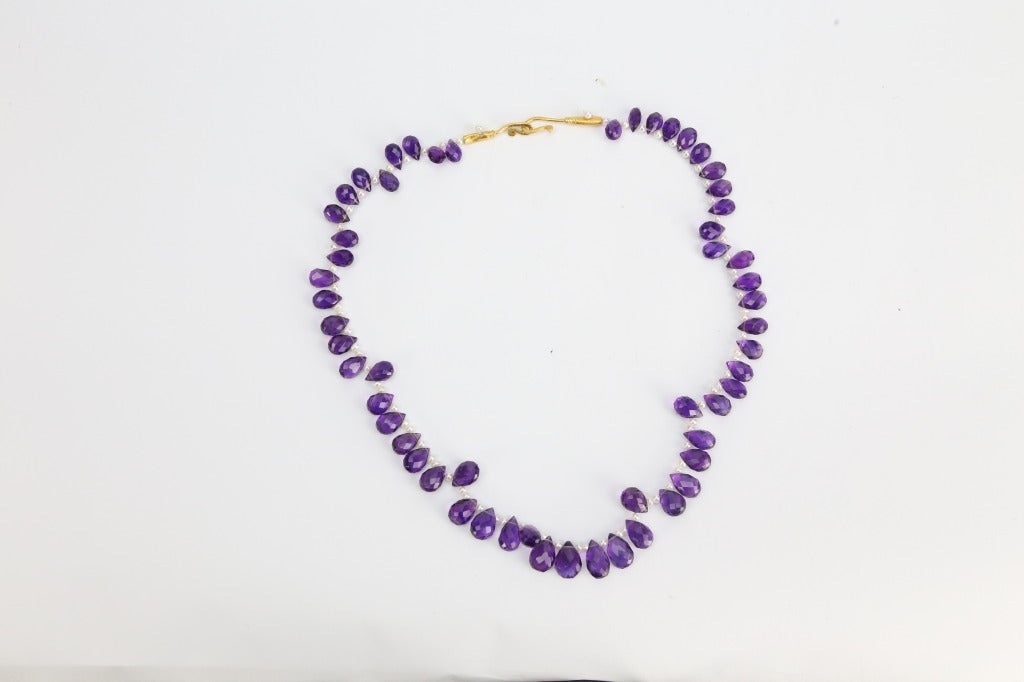 Beautiful Faceted Briolette Amethyst Necklace inter spaced with small Pearls held by a unique 18k yellow Gold Clasp, accented by two small pearls, necklace measures approx. 15” in length. Chic, Classic and Timeless…Taking you from Day to Evening