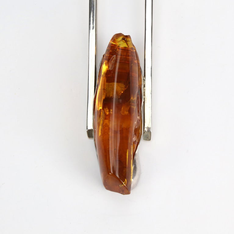 Bold and Spectacular Modernist One-of-a-Kind Necklace comprising a large Genuine Free-form Amber set in a  S/S stylized Trapeze further enhanced with S/S square, circular and doughnut beads, suspended from  5-cord strands; the necklace is finished