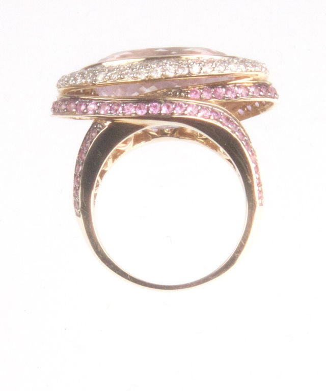 Spectacular One of a Kind Hand Crafted Retro Ring. Top set with diamonds, centered by a magnificent large oval genuine Pink Kunzite gemstone. This gemstone is the youngest member of the Spodumen family. it is also popular as a healing stone.