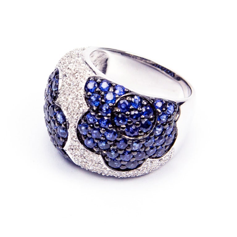 Fabulous Dome Ring Pave set with seventy-two Blue Sapphires 2.80ct and centered by 0.66carats of fifty-three round brilliant-cut Diamonds; crafted in 18k White Gold. Ring size 8. Add Pizzazz to any outfit!