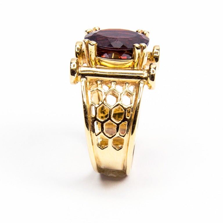 Beautiful Chic and Finely designed Ring, centering a securely set oval faceted 4.4 ct. Pyrope Garnet, mounted in hand crafted Lattice beehive mounting. Ring size: 7. We offer complimentary ring re-sizing. Illuminate your look with Timeless Beauty