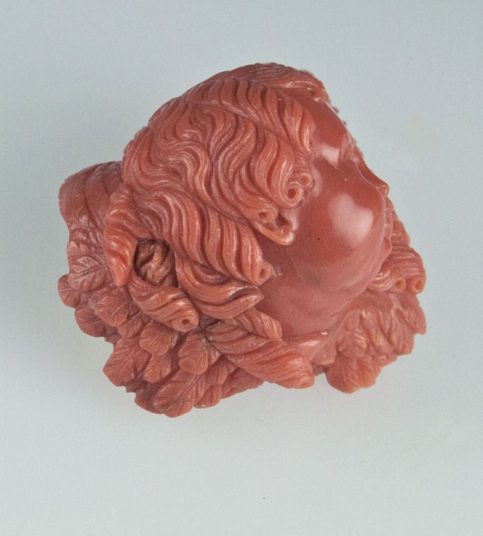 Rare Victorian Hand Carved Coral Angelic Cherub Brooch/Pendant. Beautifully carved with precision detailing, this heirloom brooch pin/pendant is a rare find and keepsake. Close inspection will show the ribbed leaf design and beautifully
executed