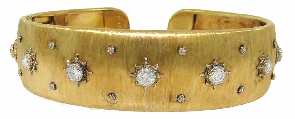 Signature Mario Buccellati bangle created in Italy in the 1960's. The highlights of this bracelet are - typical Buccellati satin finish on gold and nine Old European cut diamonds bezel set in tastefully engraved yellow gold with white gold