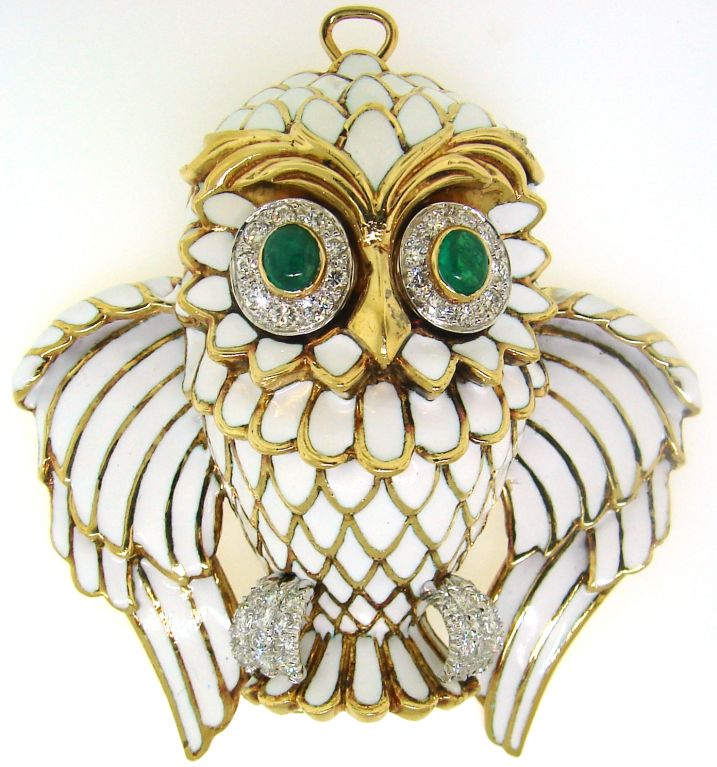 Bold and fun Owl pin created by David Webb in the 1970's. It can be also worn as a pendant (there is a hidden loop). It is made of yellow gold and white enamel and has diamonds set in platinum accents. The owl's eyes are made of cabochon emeralds.