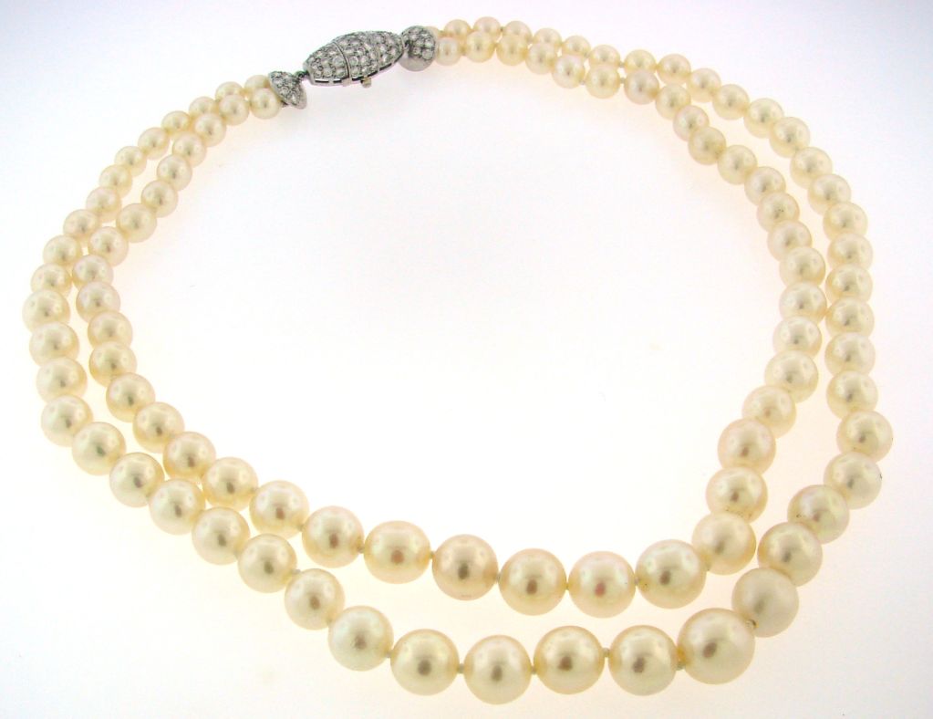 Classic and timeless two-strand white and creamy South Sea pearl necklace with a diamond clasp created by G. Petochi in Italy in the 1970's.<br />
The pearls have excellent luster.<br />
The shorter strand has forty five pearls and the longer one