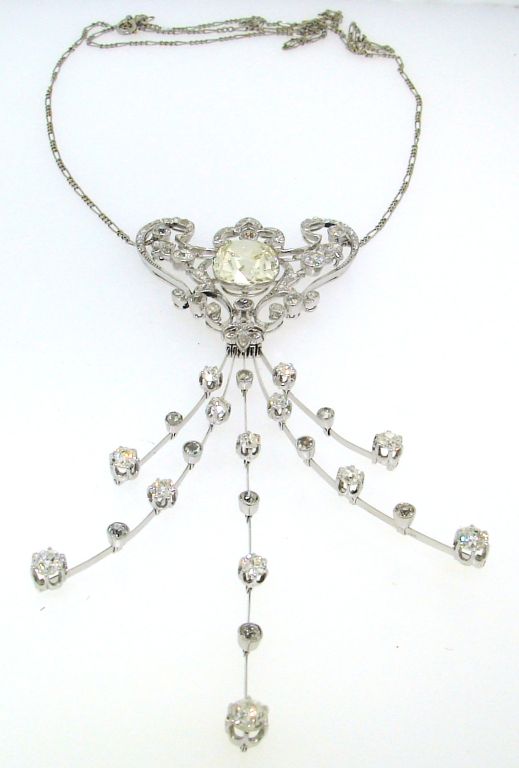 Stunning and versatile one-of-a-kind piece of jewelry - a necklace (two variations), a brooch (four variations) and a head-piece! It was created in France in the 1910's. The piece was made of platinum and set with a 6.29 cts cushion cut diamond in