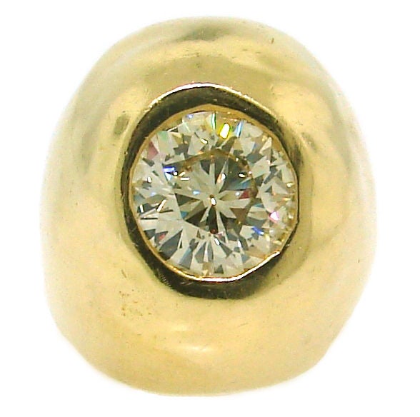 Bold and stunning ring created by Cartier New York in the 1970's. It has purposely uneven shape created by using hammered techniques. An approx. 3.14 carats Old European cut diamond(H color, VVS2 clarity) is bezel set in 18k yellow gold.<br />
The