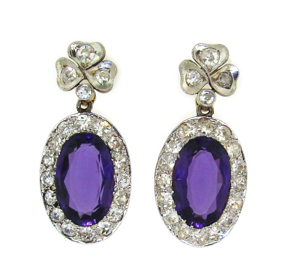 Classic elongated oval shape Victorian earrings created in Russia in the 1890's. Amazing deep purple color Russian amethyst framed with single cut diamonds and set in platinum on top and yellow gold on the bottom.