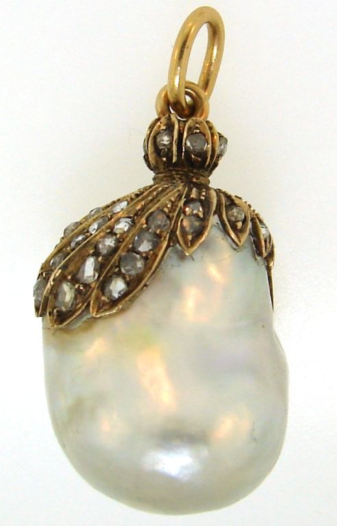 Gorgeous Georgian natural white baroque pearl tastefully encrusted to the top with rose cut diamonds set in yellow gold created in Europe in the 1890's.