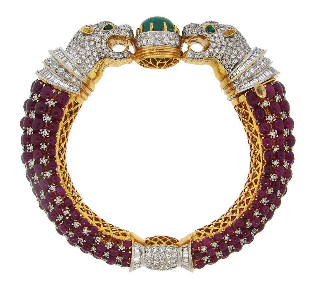 Stunning bangle depicts two panthers facing each other - a motif that inspired many jewelry houses. Encrusted with diamonds, rubies and emeralds set in yellow and white gold. Amazing workmanship!<br />
Fits up to 7.5
